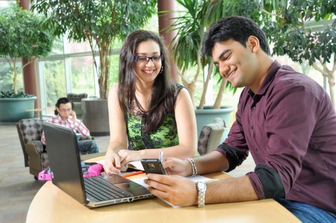 two students looking at laptop