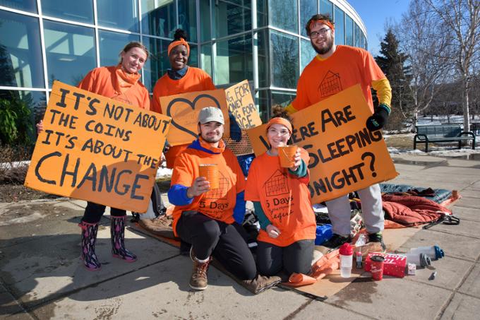A group of student is posing for the camera as they participate in a fundraising activity on campus.