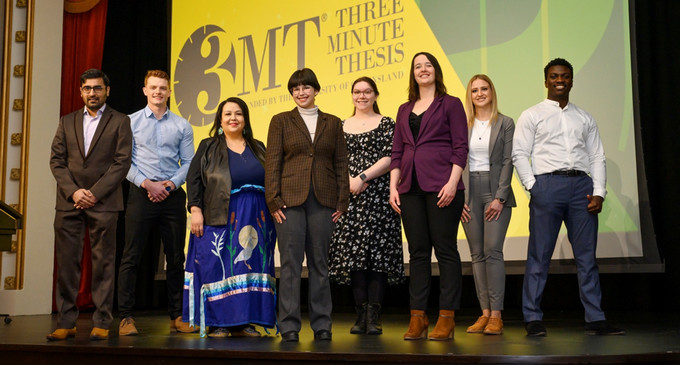 eight students standing on a stage