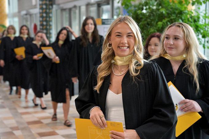 several students smiling at convocation