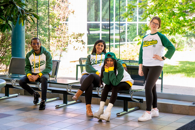 four students wearing U of R merchandise