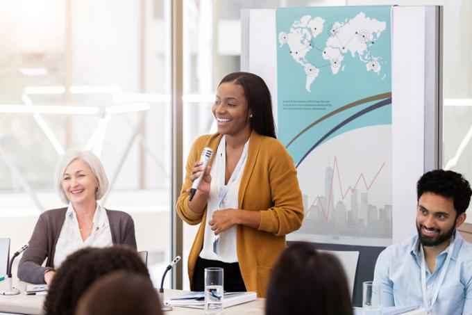 woman standing at a table speaking