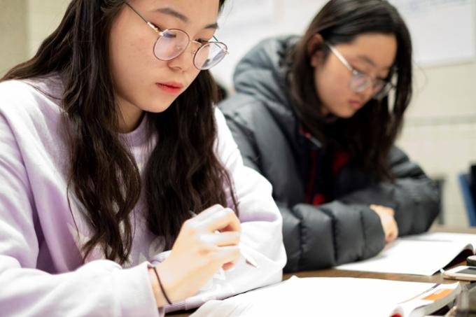 two students reading their notes together