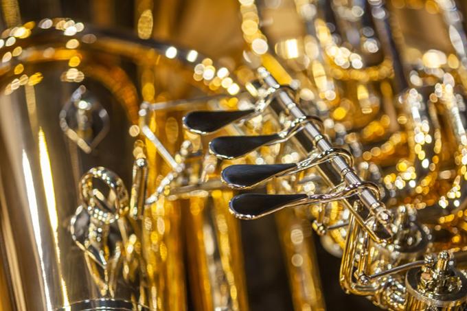 Close up of a group of shiny brass instruments. 