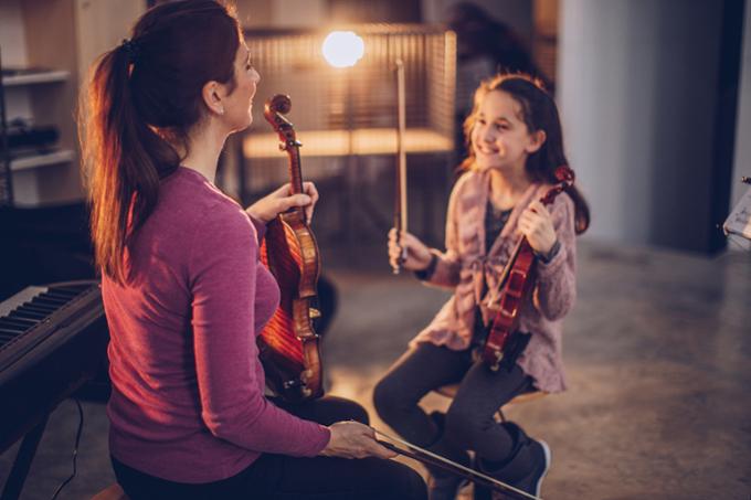 Student receiving a private violin lesson.