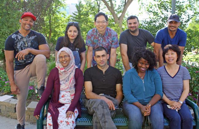 Newcomers to Canada pose together on campus
