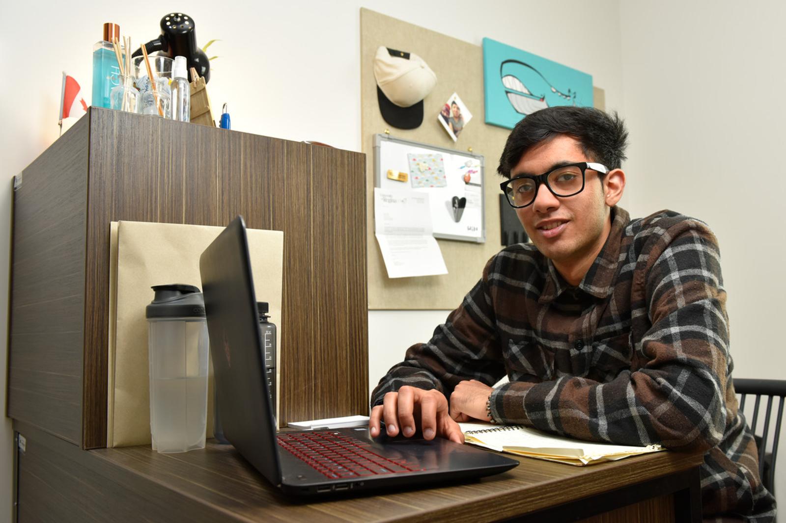 student at desk with laptop