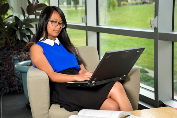 Female student reading on her laptop computer