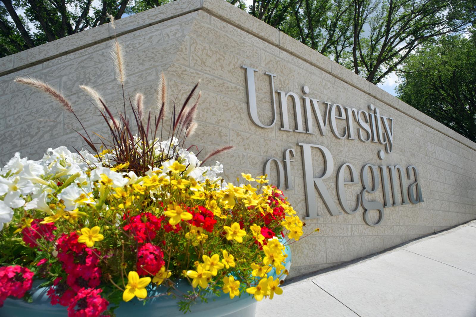 U of R sign with flowers in front
