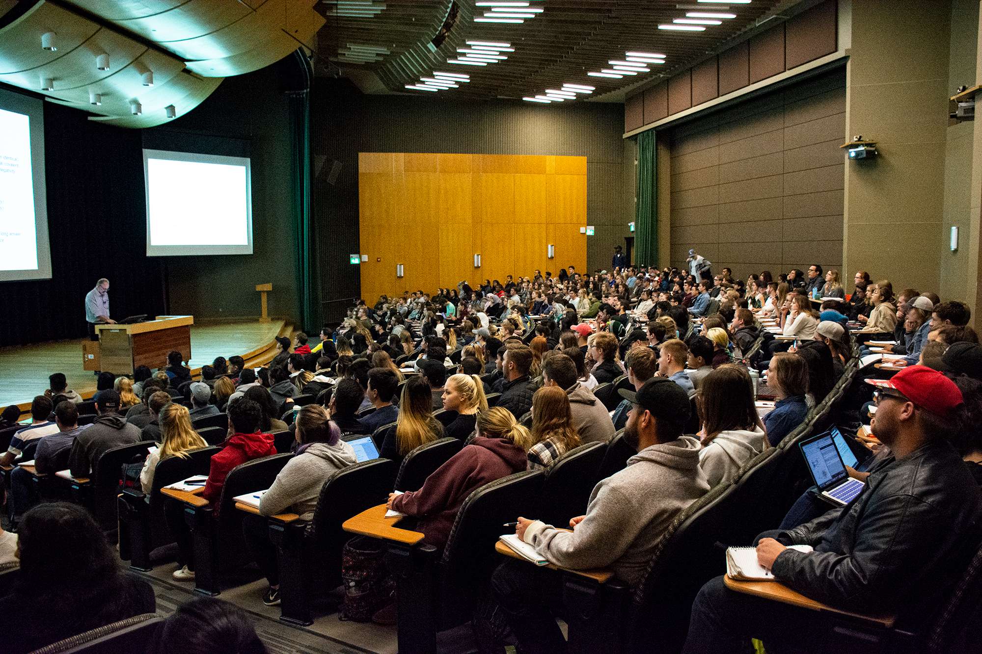 Lecture theatre full of students and a professor