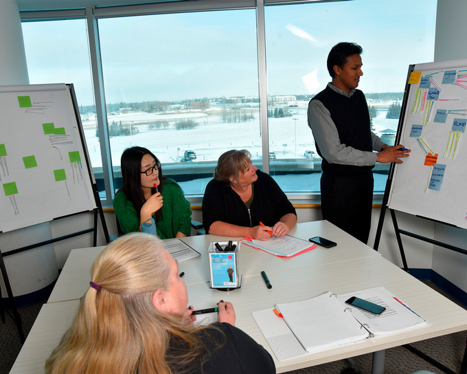 Students in a classroom doing a white board exercise