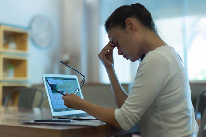 Stressed student using laptop