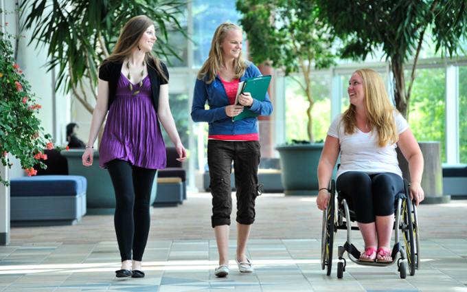 Three students visiting as they go to class.