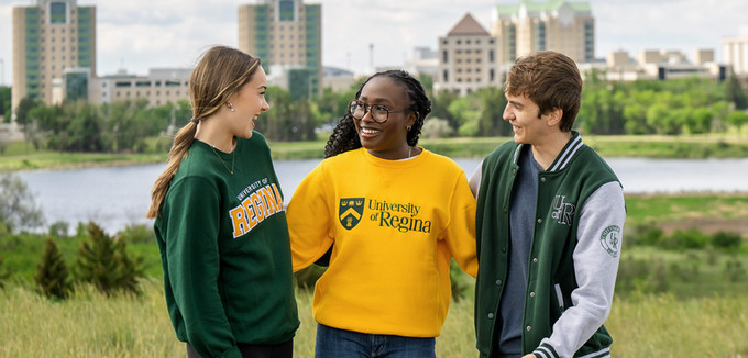Four students having fun walking across campus