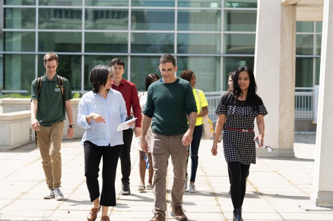 People walking outside on campus.