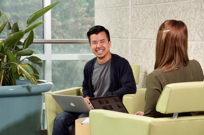 Two students sitting in chairs