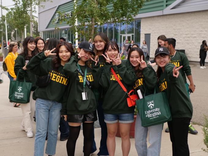 students in green u of r sweatshirts