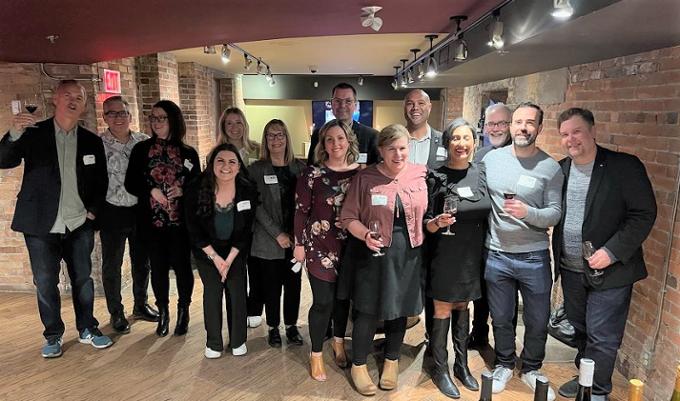 group of alumni holding wine glasses