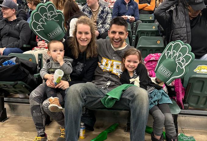 URAA President and family in the stands at basketball game