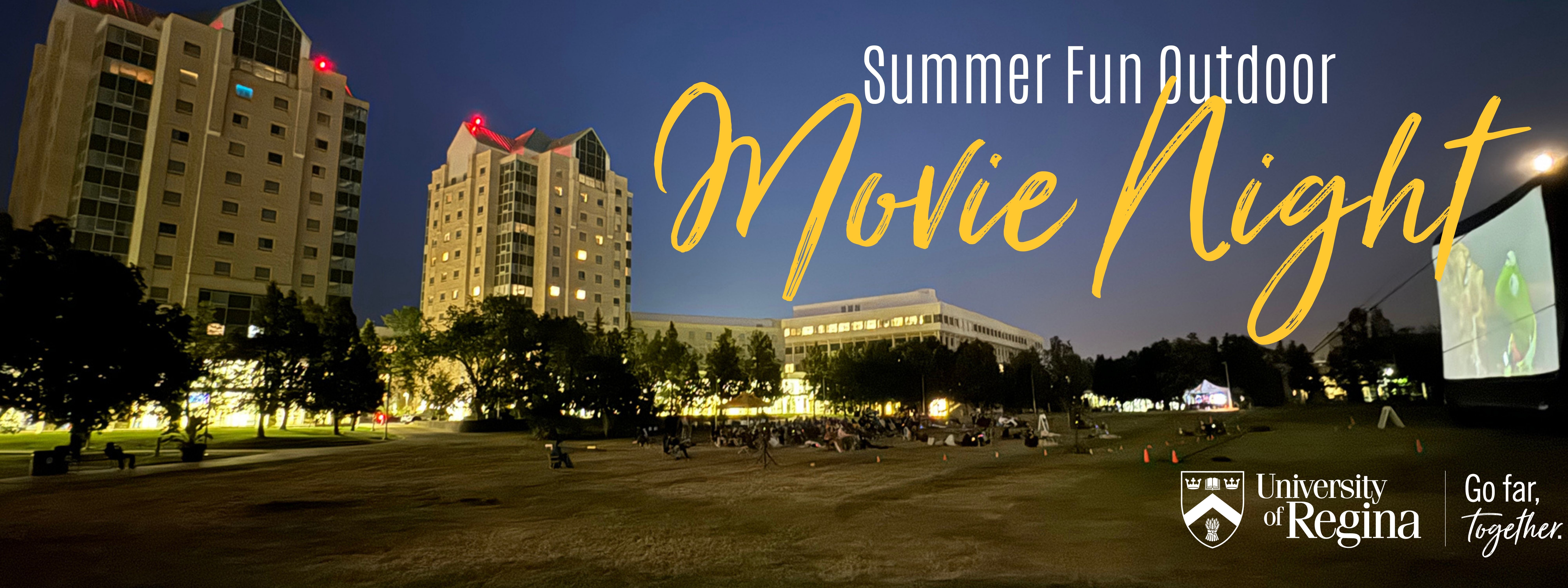 People watching outdoor movie in park