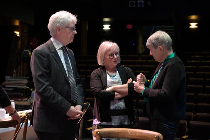 Guests network and visit at the Chancellor's Community event onstage