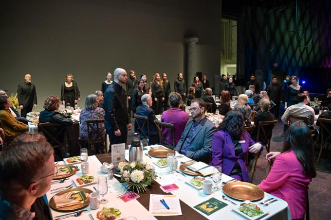 Choir sings onstage during dinner theatre