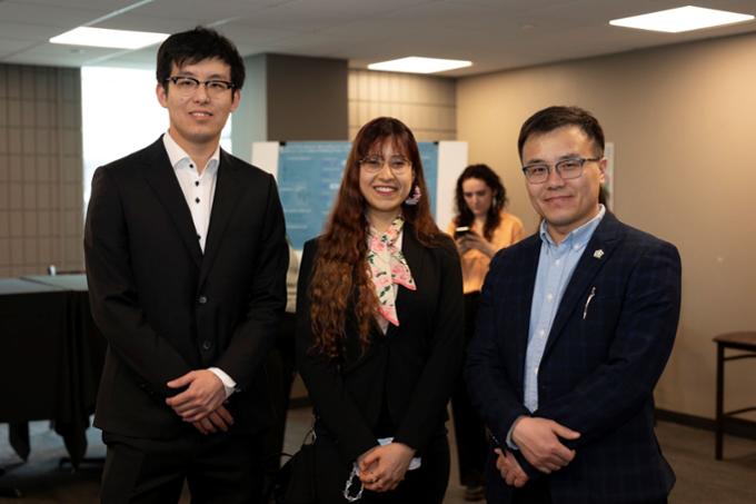 three people smile at camera at reception