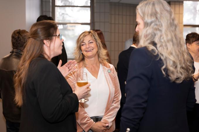 Three people talking at event