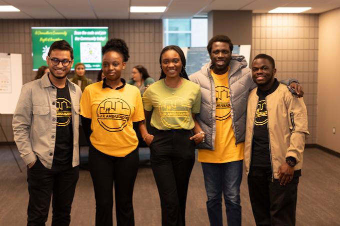 5 students smiling looking at camera