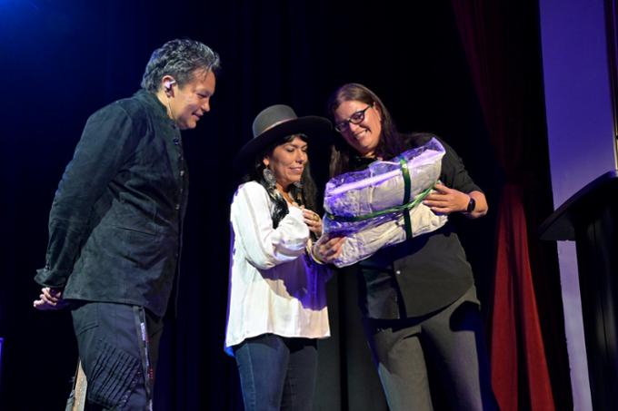 Digging Roots musicians ShoShana and Raven are presented with a blanket by Associate Vice-President Indigenous Engagement Lori Campbell on stage after the concert..