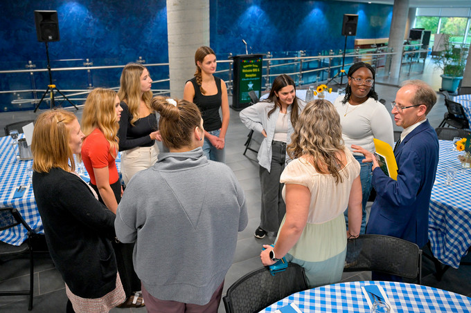 Group of people talking at an event.