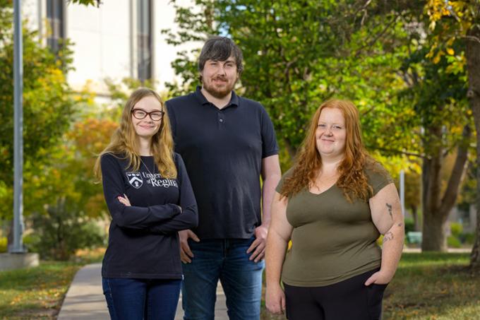 The three Finning Canada Award recipients Megan Penner, Joshua Ormerod, and Emma Gingell standing outside by the Research and Innovation Centre on campus.