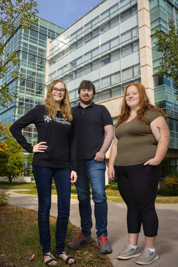 2022 Finning Canada award recipients Megan Penner, Joshua Ormerod, and Emma Gingell stand outside infront of the Research and Innovation Centre on campus.