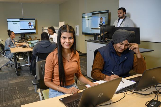 Students studying on laptops in the newly revitalized Wascana and Regina rooms in the Dr. John Archer Library and Archives.