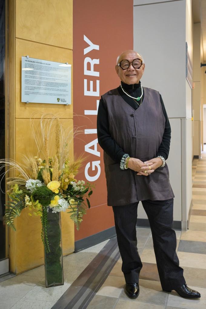 Professor Roger Lee, art historian, teacher and philanthropist, stands next to the plaque outside the front doors of the Fifth Parallel Gallery, prior to the reception honouring his generous donation to the Gallery.