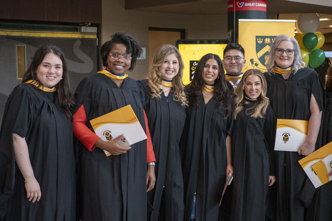 Five students stand next to each other.