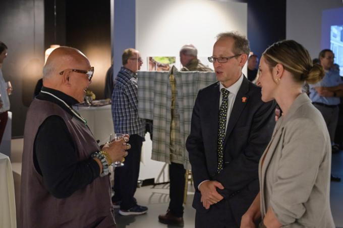 Professor Roger Lee speaks with President Jeff Keshen and Luanne Drake at the Fifth Parallel Gallery reception. 