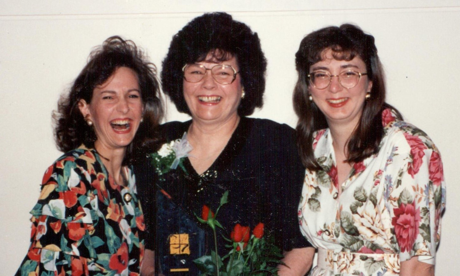 Three smiling individuals.