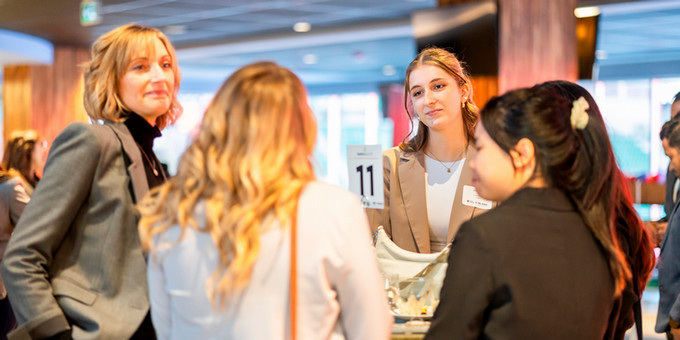 graduate student standing infront of her presentation