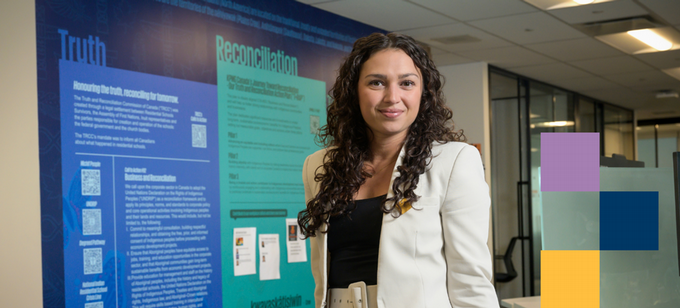 graduate student standing infront of her presentation
