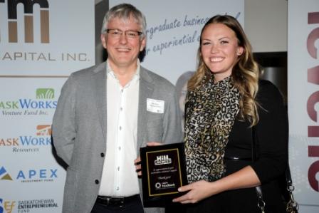Steve Compton, CEO of the Regina Food Bank, presents Hill JDC West team member, Kaitlin Zalinko with a plaque in appreciation of the team’s generous contributions to the Food Bank at the JDC West Celebration event hosted by Leaders Council on February 26.
