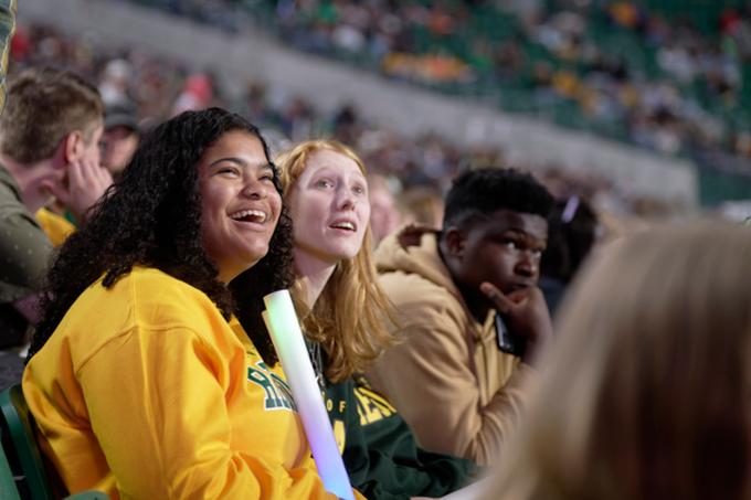 Student in stands at Rams football game.