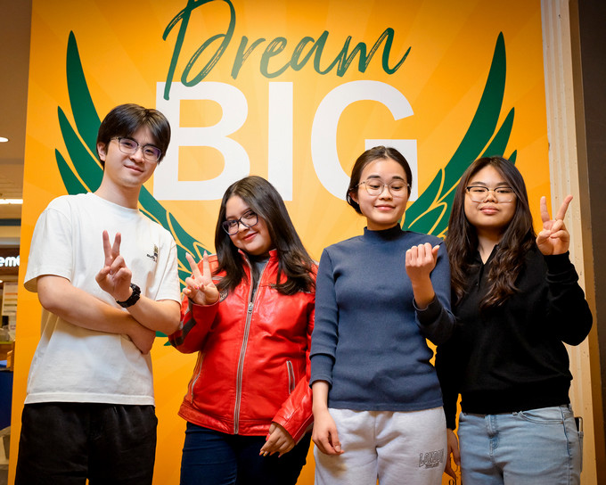 Four students pose for a photo
