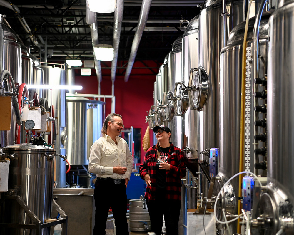 Two coworkers walk in a brewery