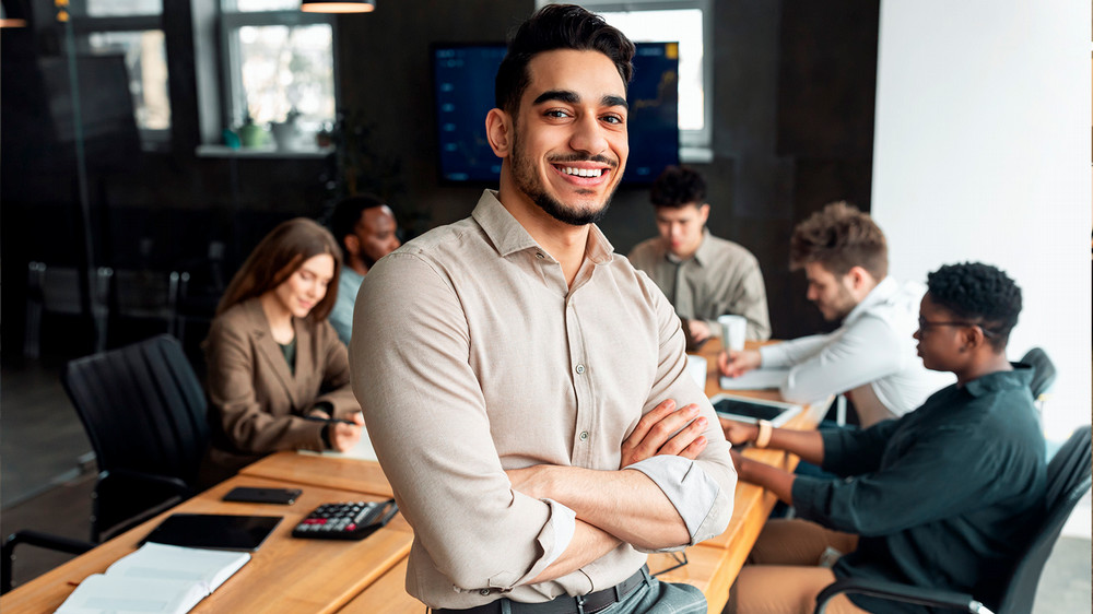 Man poses for camera in board room