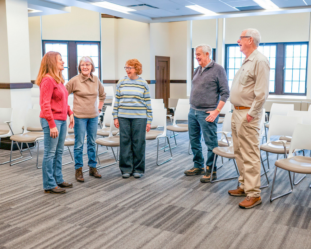 A group of senior students talking in a circle