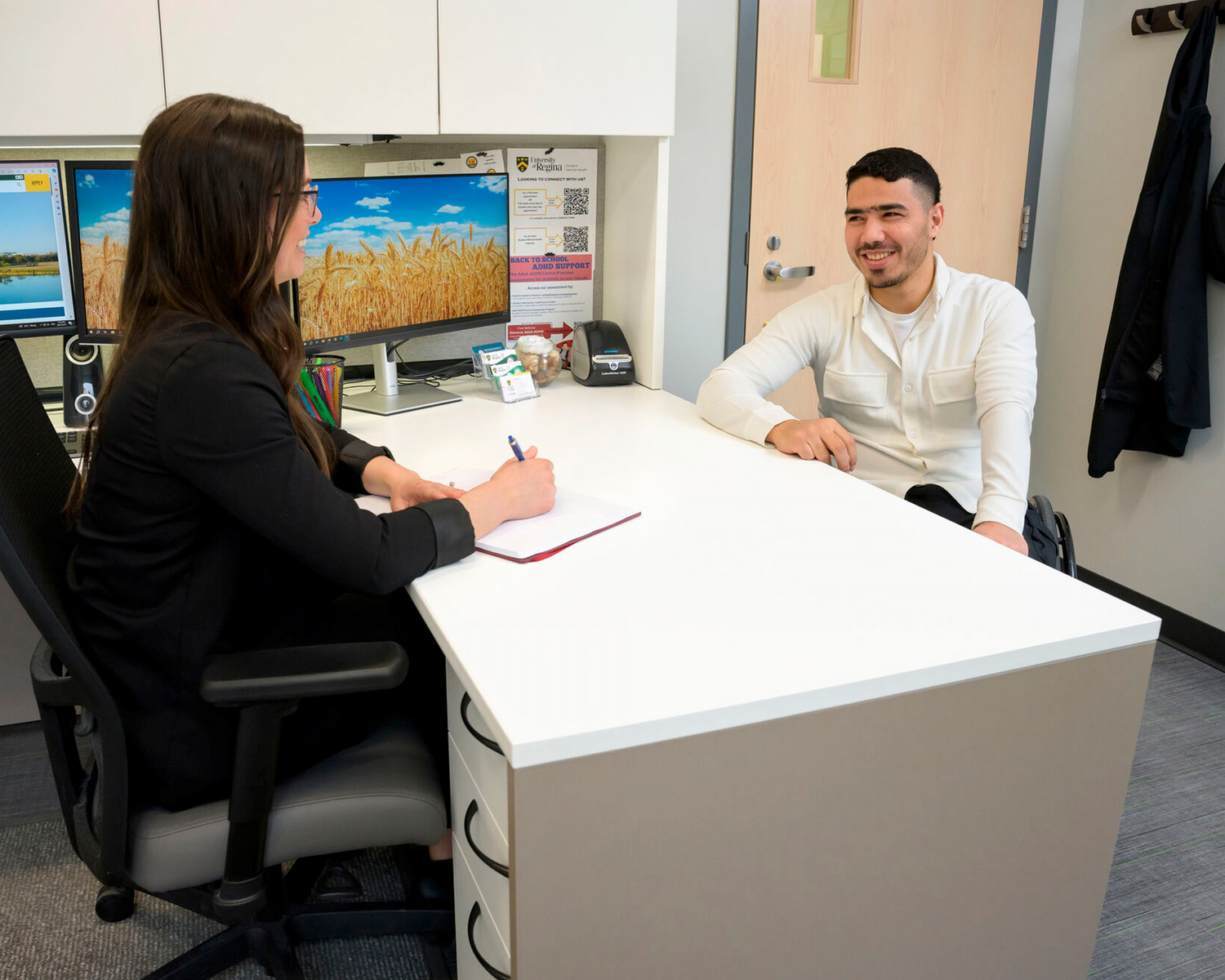 Two people discuss work