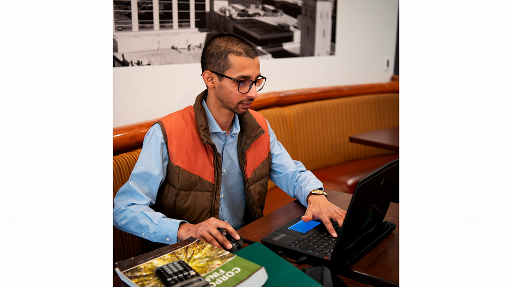 A man uses a computer at a table