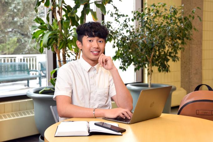 One student at desk with laptop