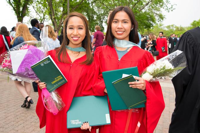 Two students at a convocation ceremony